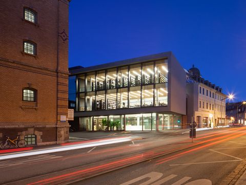 Photo: Adam Sevens 10 October, 11 am: Invitation to Renaming Ceremony University Library Building illuminated at night