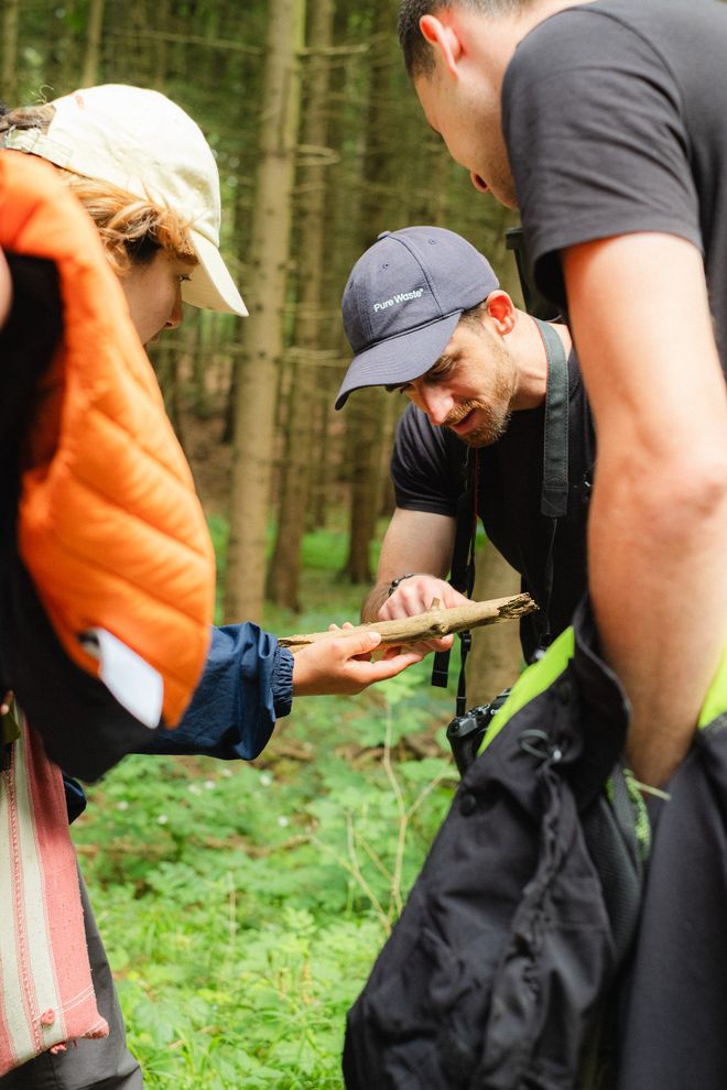 Projekt »PostCompost«, Foto: Julian Linden eine Gruppe schaut sich gemeinsam ein Stück Baumrinde an
