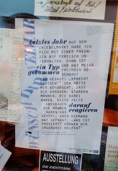 A poster with PhD Candidate Goli's quote hangs in the window display of a café in Weimar.
